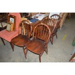 A set of four Ercol stick back chairs; and a drop