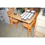 A kitchen table with a pair of chairs