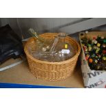 A basket containing four various glass decanters a