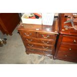 A reproduction mahogany chest fitted two short ove