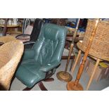 A green upholstered swivel office chair