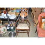 An Edwardian mahogany and inlaid rocking chair