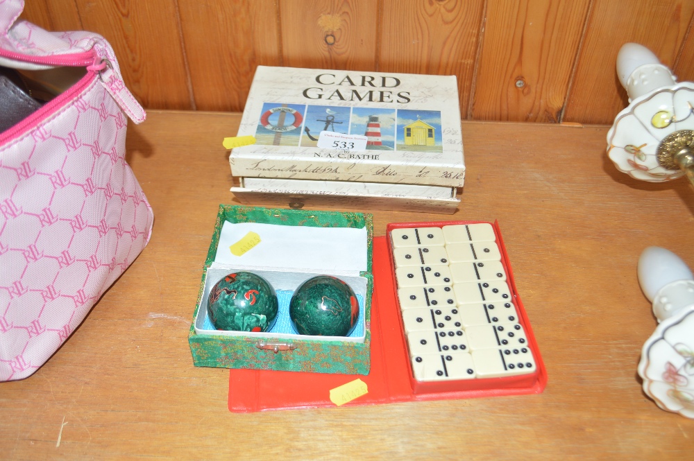 A domino set; a box of card games; two oriental mu