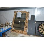 A large fret carved and bevel edged wall mirror