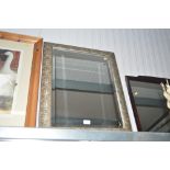 A modern rectangular bevelled edge wall mirror wit