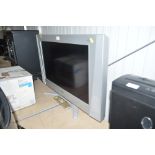 A Bush flat screen television with remote control