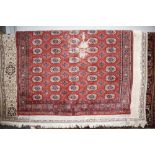 An approx. 4'3" x 2' red patterned rug with Greek