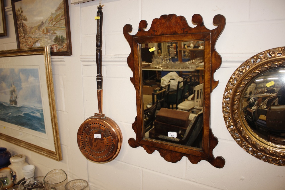 A circular gilt framed convex wall mirror; and an