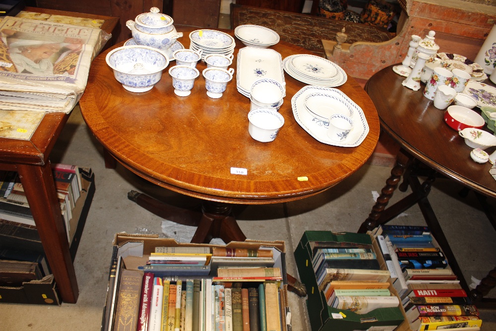 A mahogany circular topped dining table