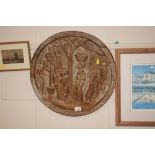 A large African carved wooden plaque depicting fig