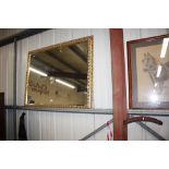 A large gilt framed and bevel edged mirror