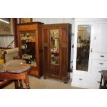 An oak single mirrored door wardrobe