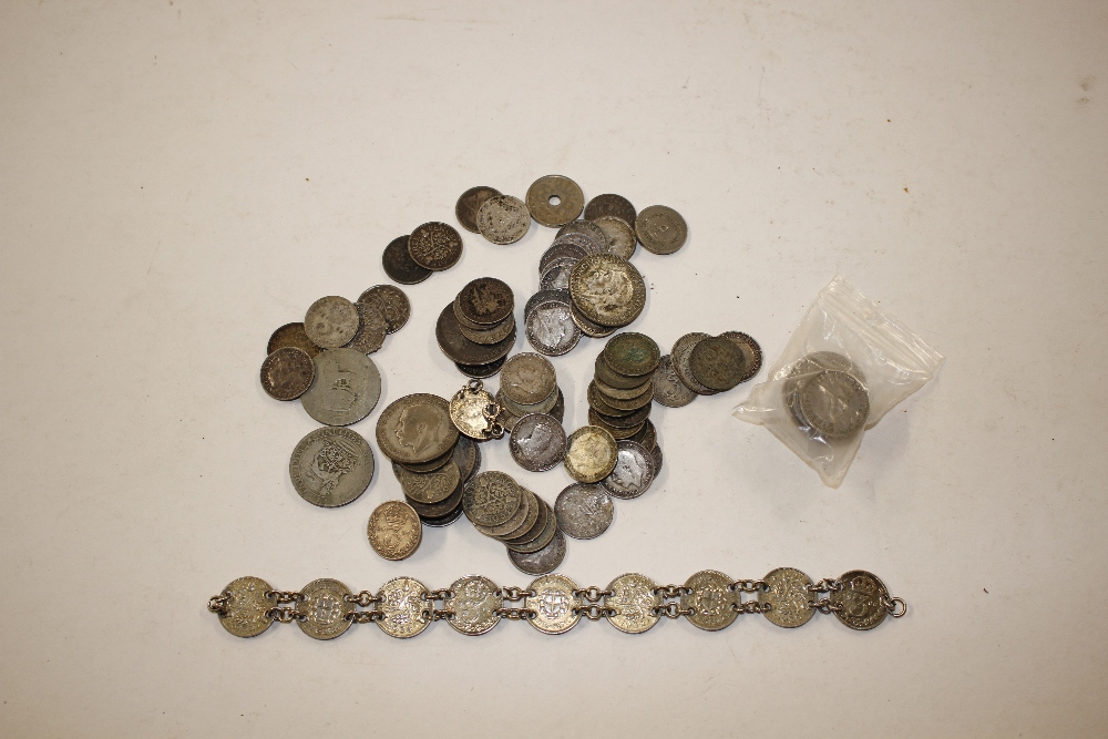 A bag containing a coin bracelet and various other