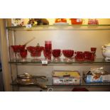 A collection of various cranberry punch cups and l