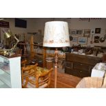 A carved mahogany standard lamp and shade