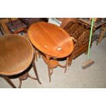 An Edwardian satin wood oval topped two tier table