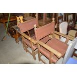 A pair of carved wooden and leather carver chairs