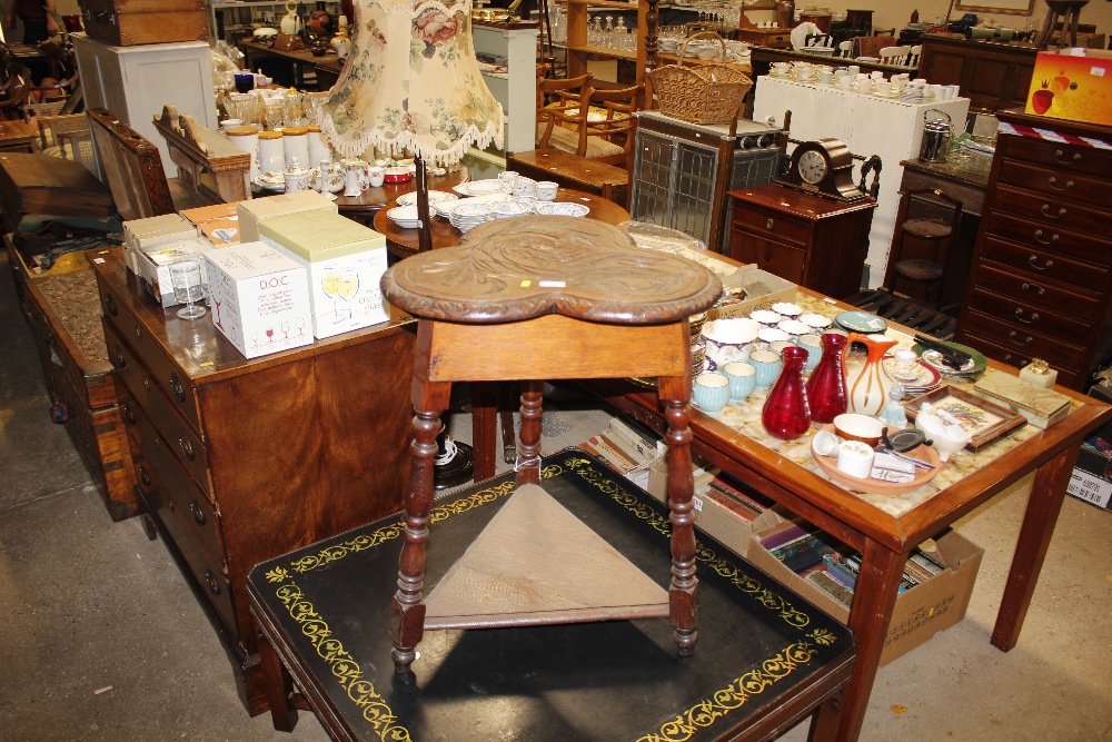 A carved oak two tier table with shaped top decora