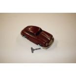 A Gescha West German tin plate wind-up toy car wit