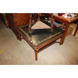 A mahogany square coffee table with painted top