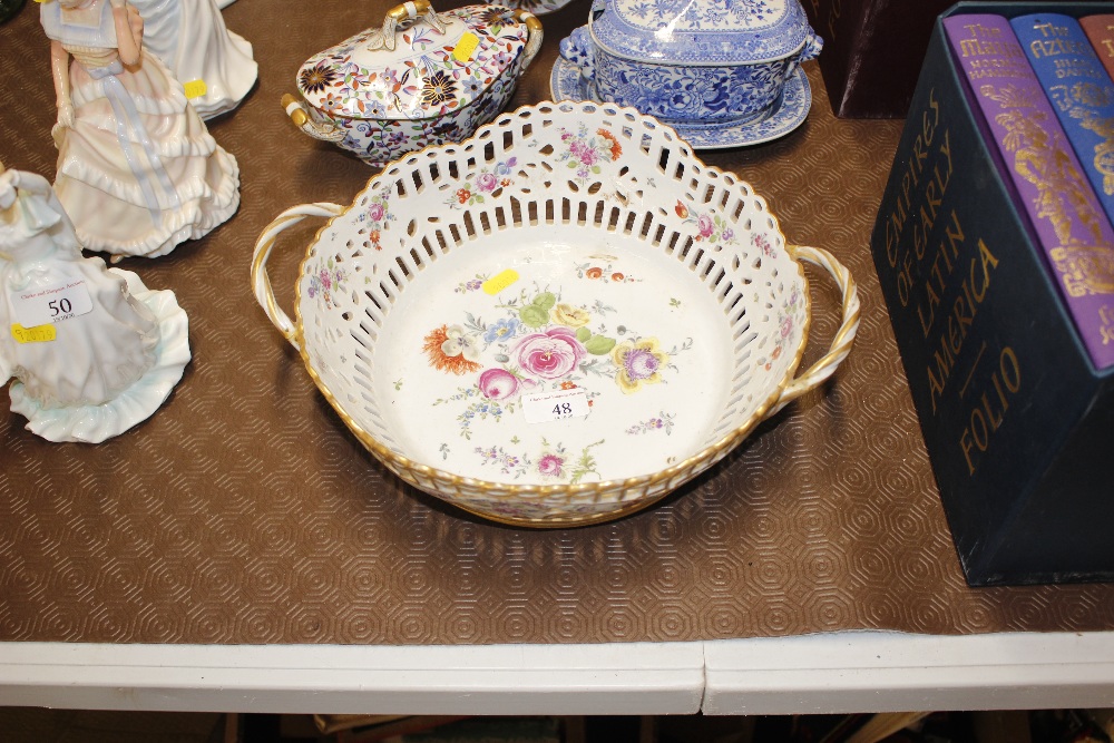 A floral painted china basket with twin handles