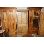 A stripped pine single door cupboard