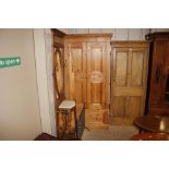 A modern pine wardrobe fitted single drawer below