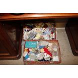 Two boxes of dolls and dolls clothes