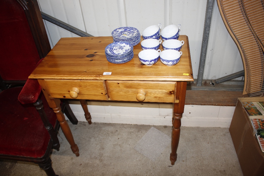 A modern pine two drawer side table