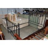 A metal and brass bed frame
