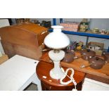 A converted oil lamp with milk glass shade