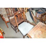 A mahogany dining chair with green velvet upholste