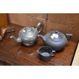 A Wedgwood Black Basalt teapot; and a matching ju