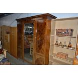 An Edwardian mirror fronted wardrobe