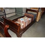 A mahogany sleigh bed