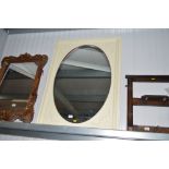 A white painted oval mirror