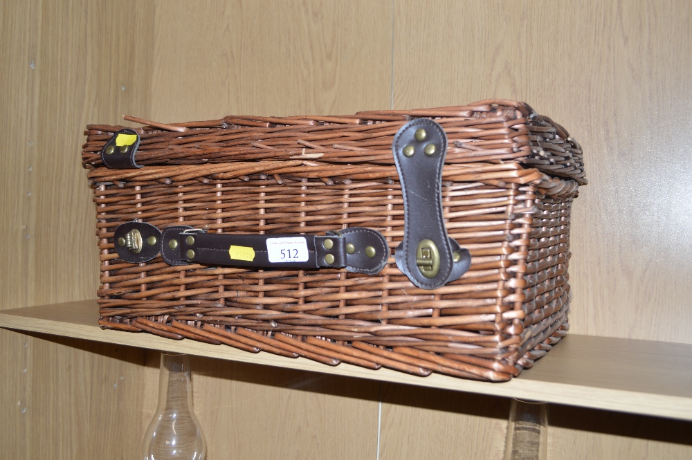 A wicker picnic hamper lacking contents