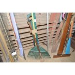 A bundle of long handled gardening tools