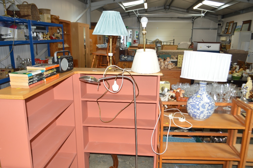 Two brass table lamps; a floor standing adjustable