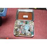 A tin of various ear-rings and brooches; and a qua