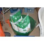 A plastic tub and two bags of pure wood pellets