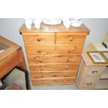 A modern pine chest fitted two short over five lon