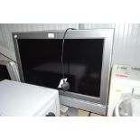 A Toshiba flat screen television with remote contr