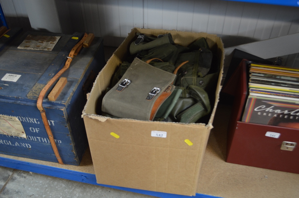 A box containing various military gators, webbing