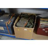 A box containing various military gators, webbing