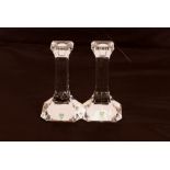 A pair of Orrefors block glass candlesticks, 19.5c