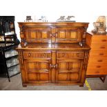 An Ercol court cupboard 145cm wide x 140cm high