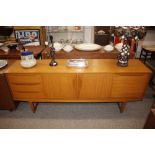 A teak effect sideboard fitted three drawers, cent