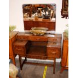 A 1930's oak dressing table, having raised bevelle