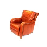 A good quality tan leather armchair, raised on tur